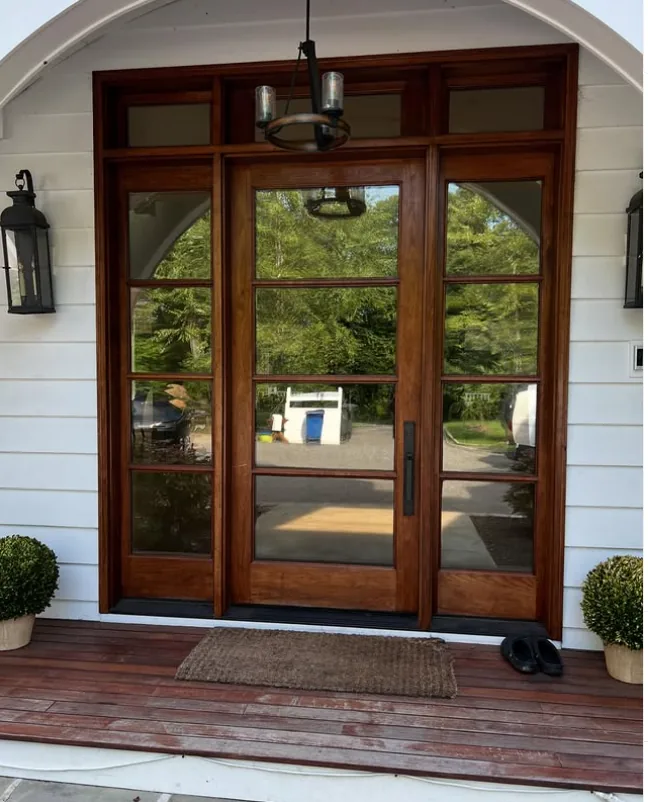 Wood-framed front entry with sidelights and transom glass tinted with 35% ceramic film