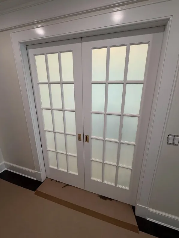 White French pocket doors with frosted privacy film applied to every glass pane